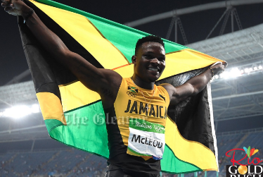Omar Mcleod parading  the Jamaican flag after after winning jamaican 1st 110m hurdies gold medal